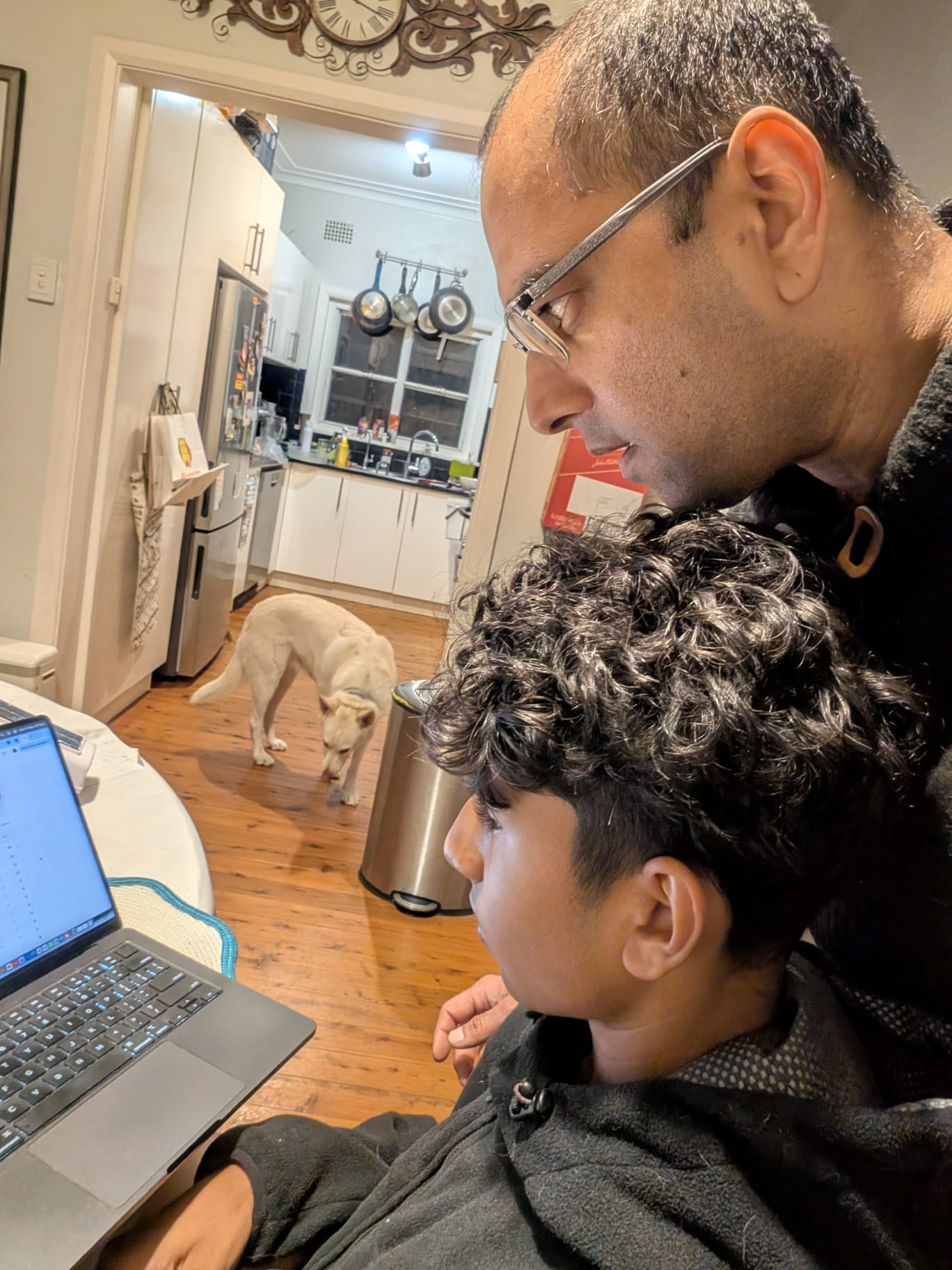 Krish and his son Sid at the kitchen table, building TribePicks on a laptop